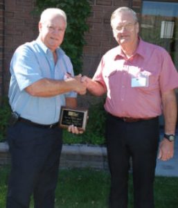 Paul Hoggatt (left) accepts congratulations from John Chrysler upon receiving a 2008 TMS Service Award for his exceptional service.