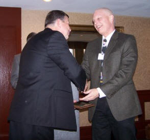 Bill Wood (right) accepts congratulations from Phillip Samblanet (left) upon receiving a 2007 TMS Service Award.