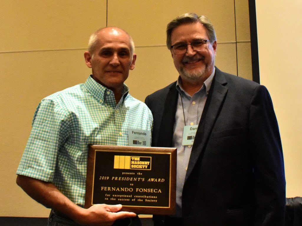 Fernando Fonseca (left) receives the 2019 President's Award from Darrell McMillian