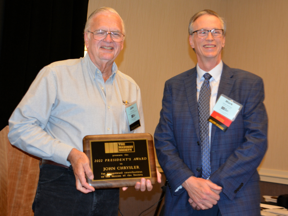 John Chrysler (left) is awarded the 2022 President's Award from W. Mark McGinley