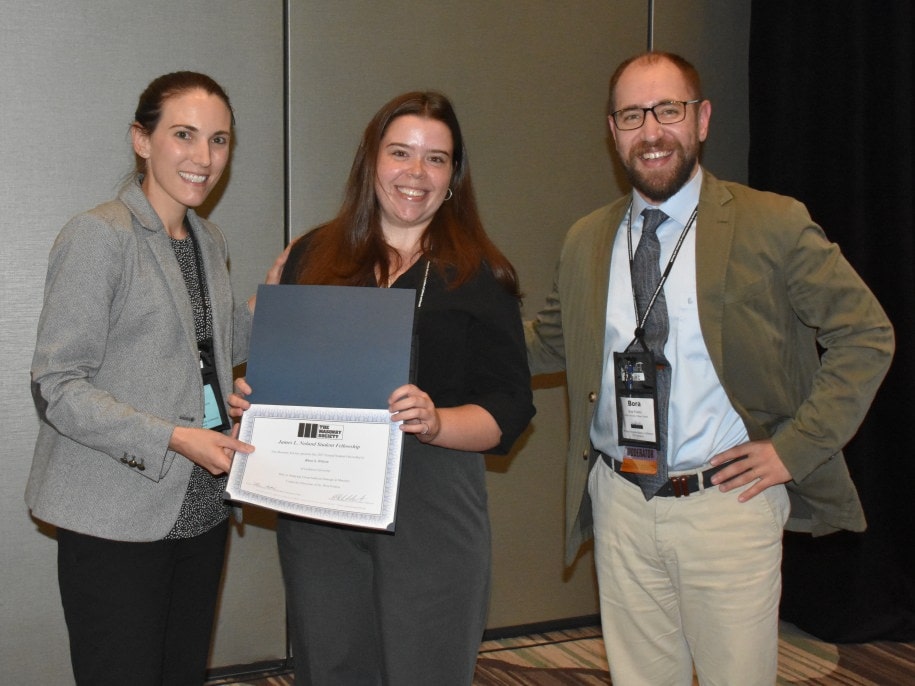 Rhea Wilson (center) receives the James Noland Student Fellowship from Dr. Laura Redmond, Scholarships Committee Char, as her advisor,Dr. Bora Pulatsu, looks on.